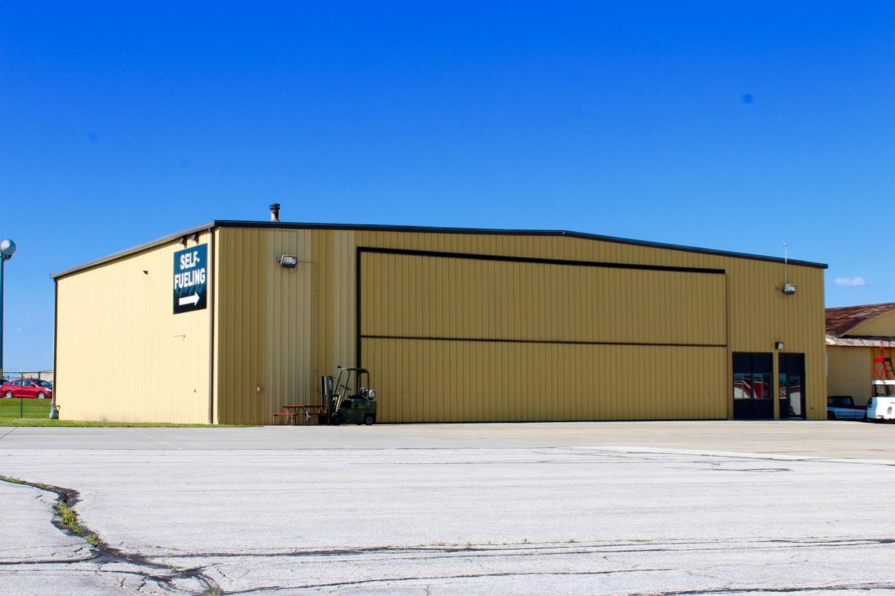 Hangar with self-fueling sign